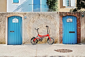 Foldable electric bike in a smaal town at the front door