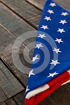 Folded American flag on wooden table