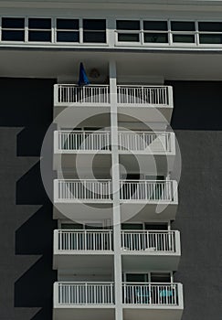 Folded beach umbrella at the balcony of the top floor
