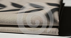 Folded beige linen fabric with a