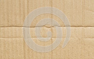 Folded corrugated cardboard surface texture background. Seamless crumpled brown paper textured backdrop