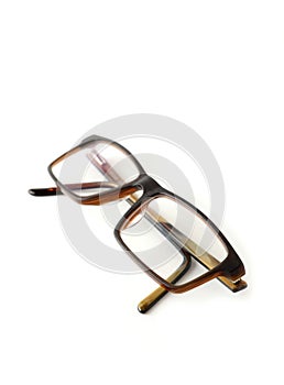 Folded eyeglasses on white background