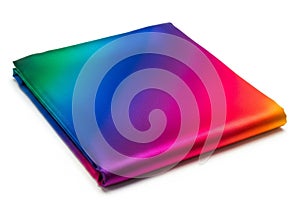 Folded fabric featuring a gradient of vibrant colors, including green,