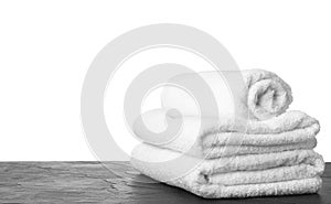 Folded fresh clean towels for bathroom on table against background. Space for text