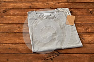 Folded Gray t-shirt on wooden background