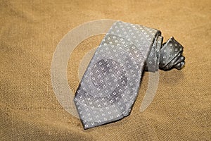 Folded grey tie on the old tissue
