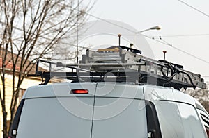 Folded ladder on top of van