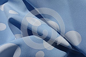 Folded light blue rayon with polka dot pattern