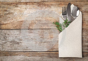 Folded napkin with fork, spoon and knife photo