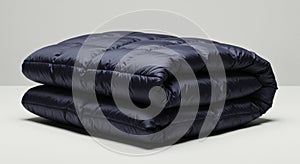 Folded Navy Blue Down Comforter or Blanket on a White Surface