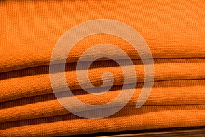 Folded orange sweatshirts