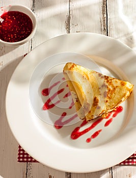 Folded pancake on white plate