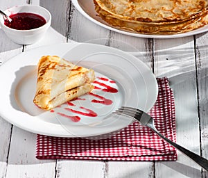 Folded pancake on white plate