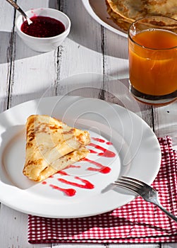 Folded pancake on white plate