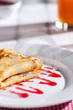 Folded pancake on white plate