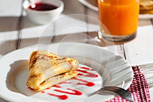 Folded pancake on white plate