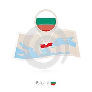 Folded paper map of Bulgaria with flag pin of Bulgaria