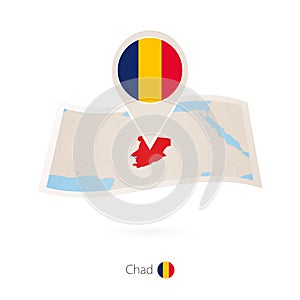 Folded paper map of Chad with flag pin of Chad