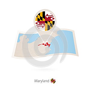 Folded paper map of Maryland U.S. State with flag pin of Maryland