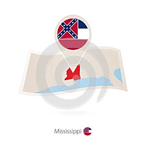 Folded paper map of Mississippi U.S. State with flag pin of Mississippi