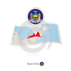 Folded paper map of New York U.S. State with flag pin of New York