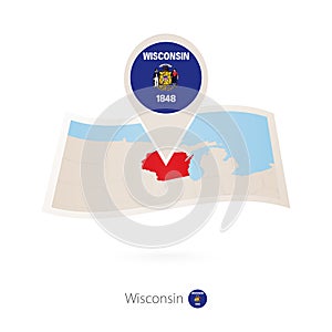 Folded paper map of Wisconsin U.S. State with flag pin of Wisconsin