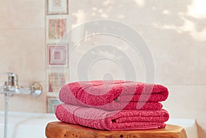 Folded pink towels in bathroom