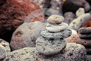 Folded pyramid of smooth stones on the seashore, zen stone