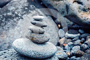 Folded pyramid of smooth stones on the seashore, zen stone