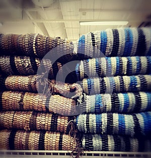 Folded rugs on sale in a store.