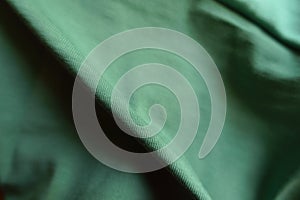 Folded unprinted juniper green cotton fabric