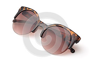 Folded spotted brown framed sunglasses photo
