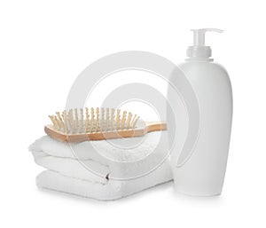 Folded towel, hair brush and shampoo