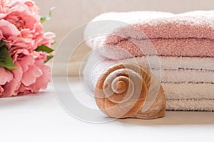 Folded towels on bathroom counter with flowers