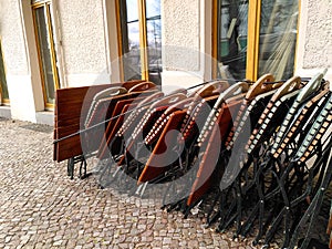 Folded up garden chairs and tables from a street restaurant in Friedrichshain, Berlin, Germany during coronavirus lockdown