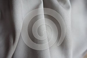Folded viscose and polyester fabric with tie-dye pattern in shades of gray