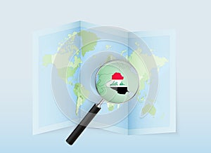 A folded world map with a magnifying lens pointing towards Iraq. Map and flag of Italy in loupe