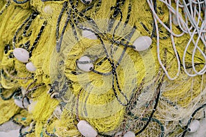 Folded yellow fishing net with white floats. Top view