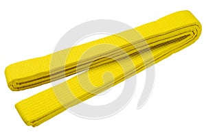 Folded yellow kimono belt for judo, karate or other martial arts, on a white background