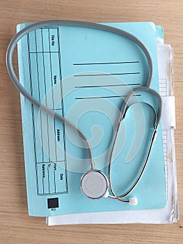 folder file and stethoscope on desk