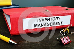 Folder with papers about Inventory Management and pen. photo