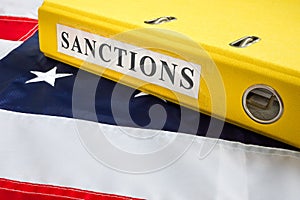 Folder with sanctions law and USA flag.