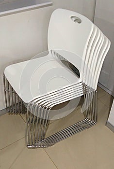 A folder of white chairs.