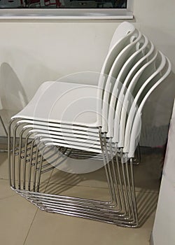 A folder of white chairs.