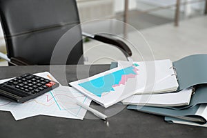 Folders with documents and calculator on office