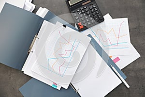 Folders with documents and calculator on office table