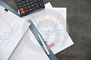 Folders with documents and calculator on office table