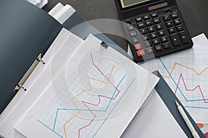 Folders with documents and calculator on office table