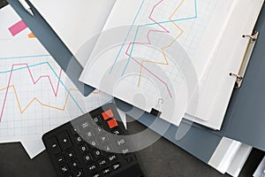 Folders with documents and calculator on office table