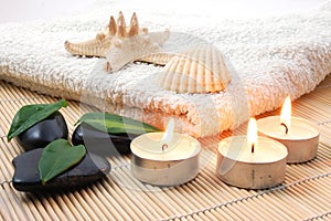 Foldet white bath towel and zen stones